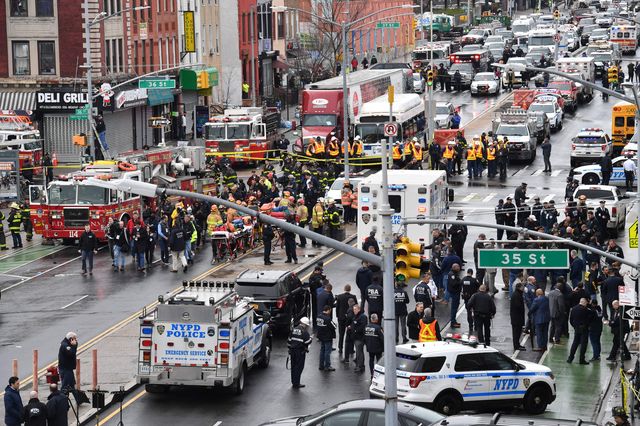Members of the New York Police Department and emergency vehicles crowd the streets after a subway shooting in Brooklyn Tuesday.